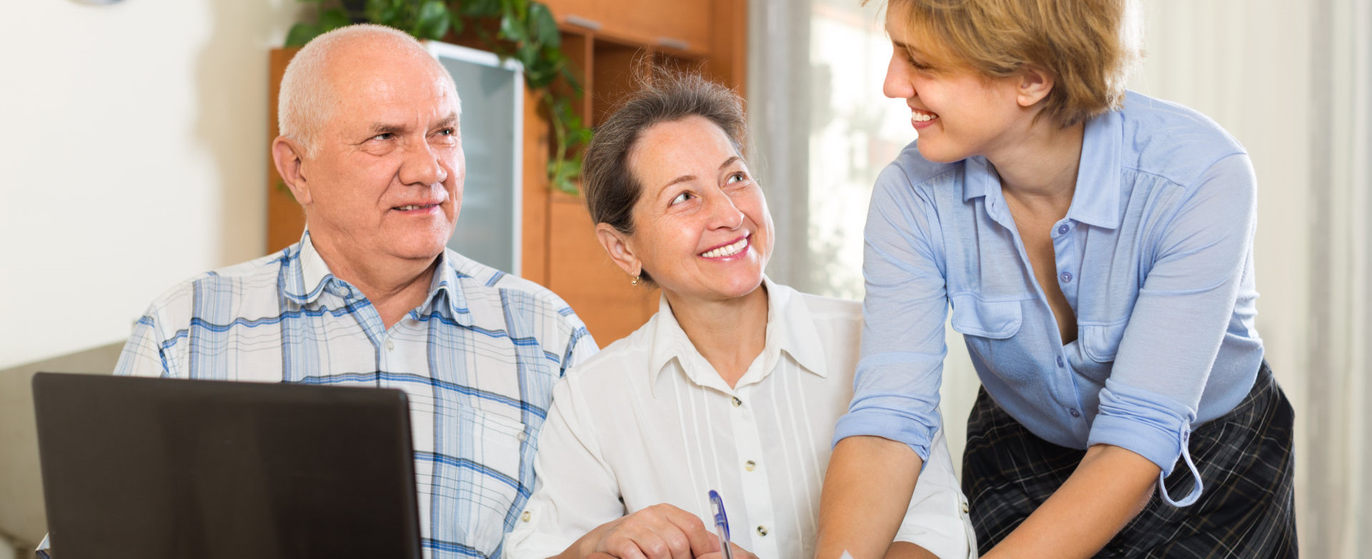 woman assisting senior couple