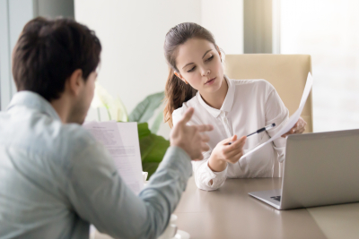 man and woman holding some documents