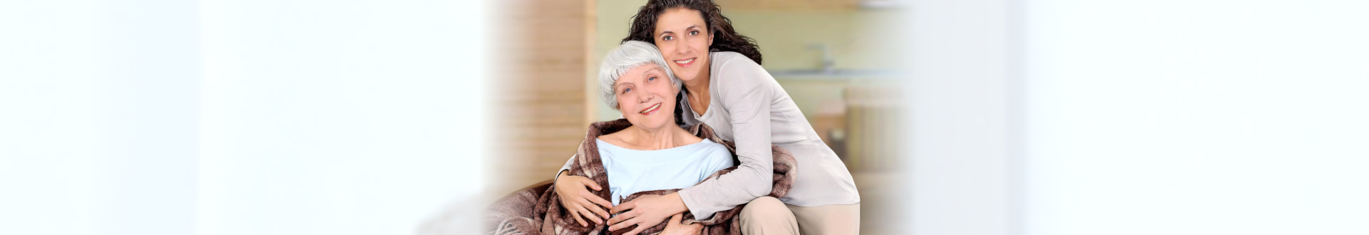 caregiver hugs a senior woman